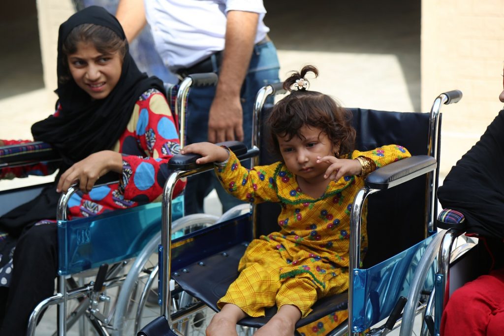 Girls with disabilities sitting on wheelchairs